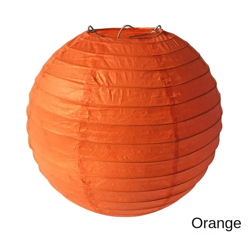 An orange paper lantern with a round, pleated design.