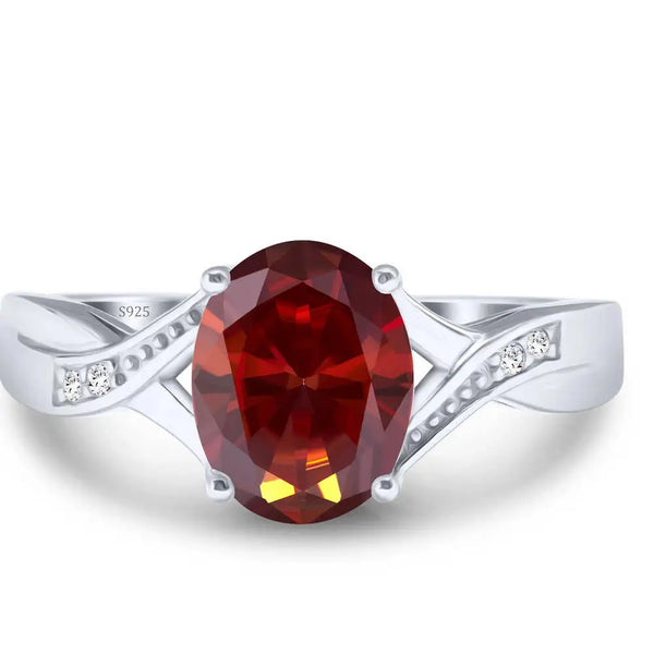 A dainty moissanite fairy charm ring in 925 sterling silver featuring a round, deep red gemstone.