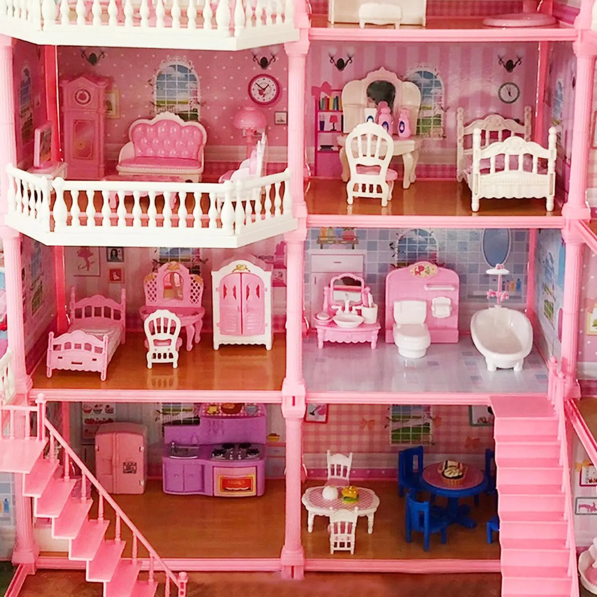 A pink dollhouse featuring miniature rooms with furniture like beds, chairs, and decorative items.