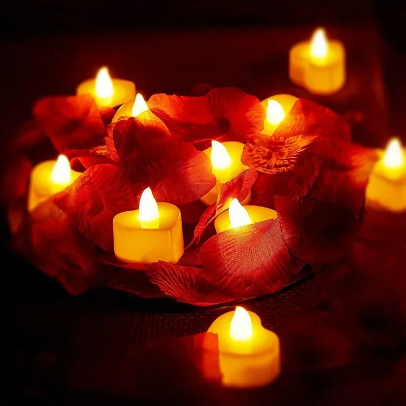 A cluster of heart-shaped orange candles glowing brightly in a dark setting.