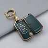 A green TPU key fob cover with a gold chain and ring attached, shown against a gray background.