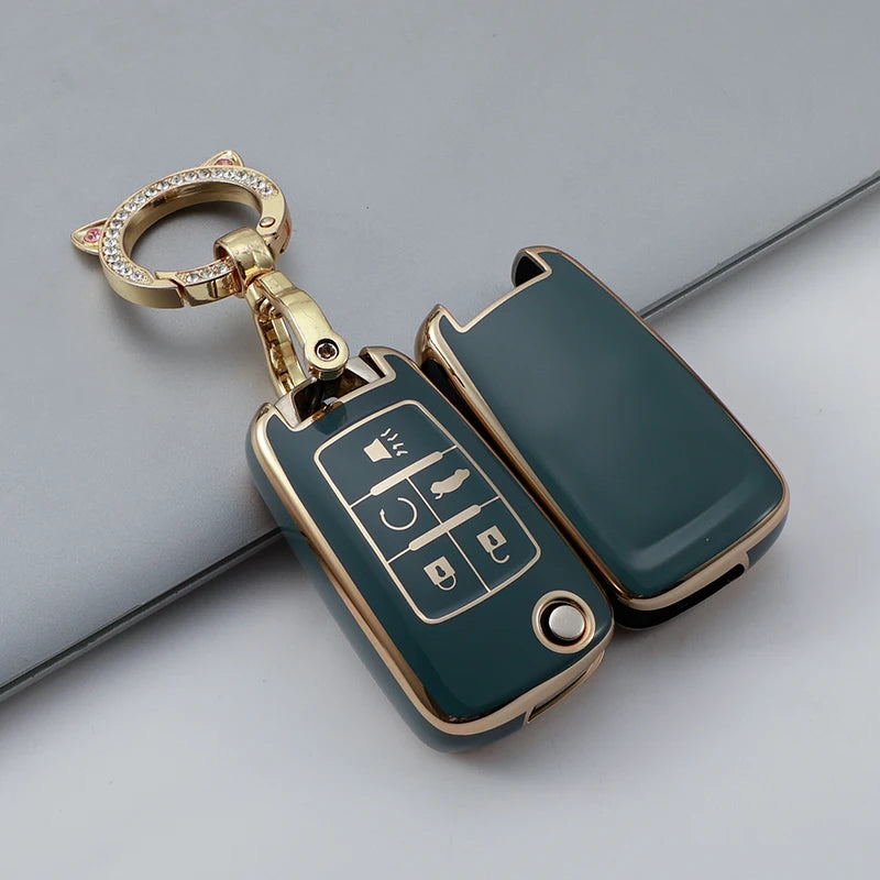 A gold-toned TPU key fob cover for a vehicle, featuring a green-colored fob with buttons.