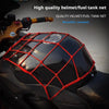 A red bungee cargo net is installed on a black motorcycle fuel tank for protection.