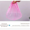 A hand is holding a pink, thickened waterproof new pe material shower cap bag.