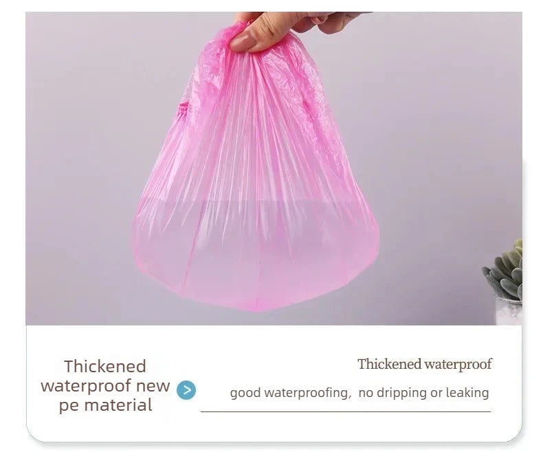 A hand is holding a pink, thickened waterproof new pe material shower cap bag.