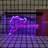 A neon sign shaped like a stylized mountain outline with the word Nürnbergg glowing purple against a grid background.