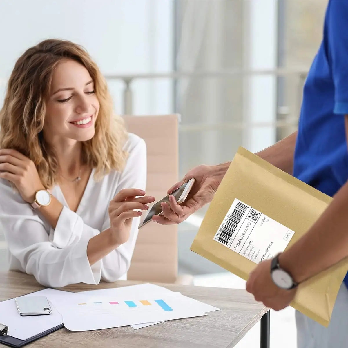A woman is sealing a kraft bubble mailer with self-seal adhesive in an office setting.