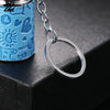 A close-up of a light blue metal coin tube keychain with a silver chain and circular ring attached.