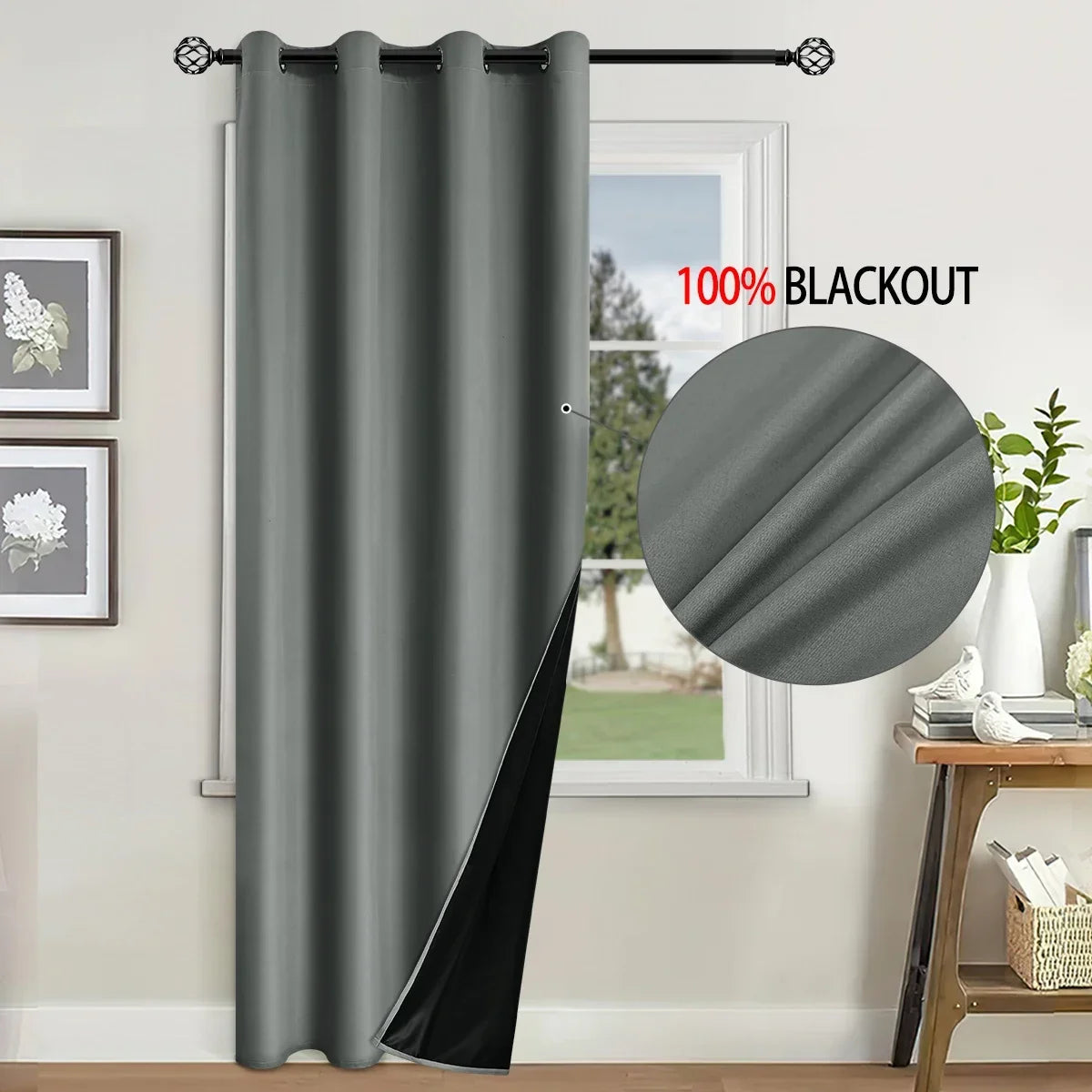 A gray blackout curtain hanging in a window, showing its texture and blackout feature.
