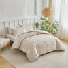 A beige embossed leaf pattern microfiber duvet cover set displayed on a bed with white bedding and natural light.