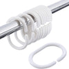 A close-up of a white, spiral shower curtain rod with multiple rings and a circular ring.