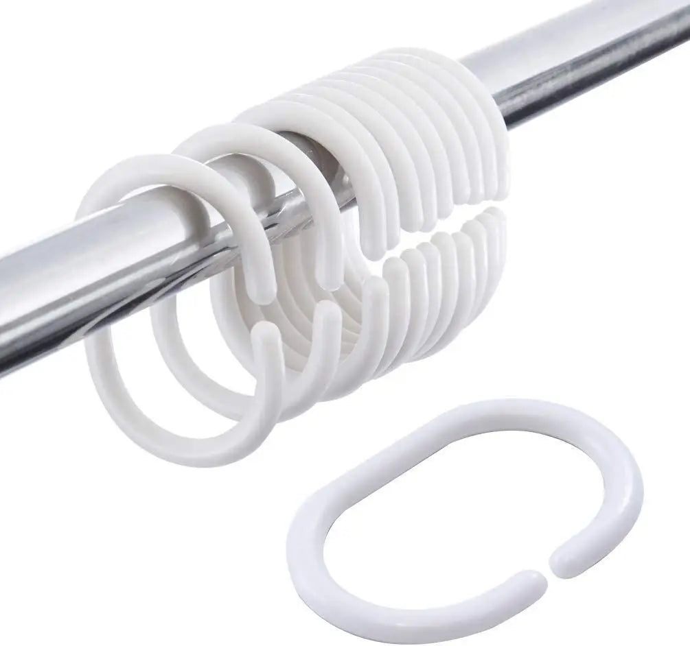A close-up of a white, spiral shower curtain rod with multiple rings and a circular ring.