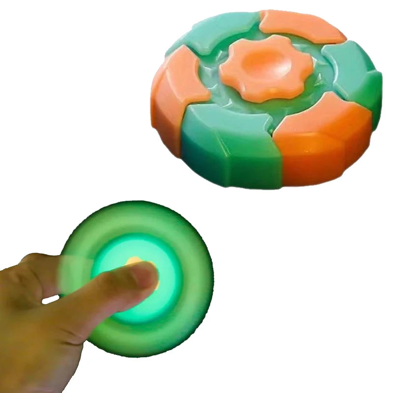 A colorful magnetic fidget slider with green and orange segments is being held by a hand.