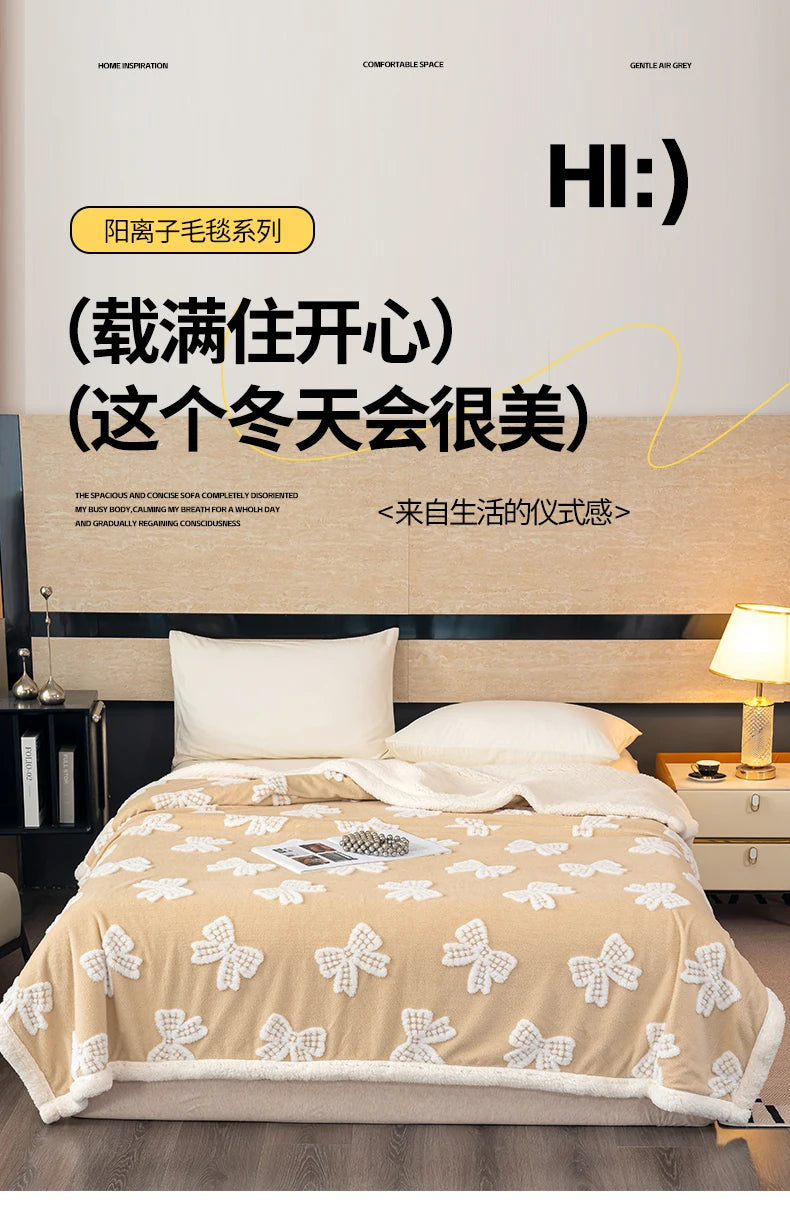 A beige plush jacquard throw blanket is displayed on a bed, featuring white butterfly patterns.