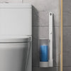 A white disposable toilet brush set with a wall-mounted holder is shown next to a toilet.