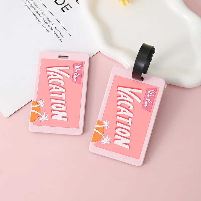 Pink silicone luggage tag with vacation text and a floral design attached to a black strap