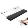 An ergonomic acrylic keyboard stand with a memory foam wrist rest shown next to a hand typing on a laptop.