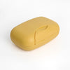 A compact, yellow leak-proof travel soap box with a rounded, ergonomic design.