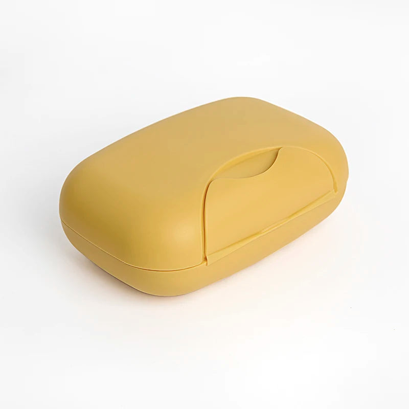 A compact, yellow leak-proof travel soap box with a rounded, ergonomic design.