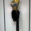 A mannequin displays a sparkly two-piece party outfit featuring a sheer top and a black draped skirt.