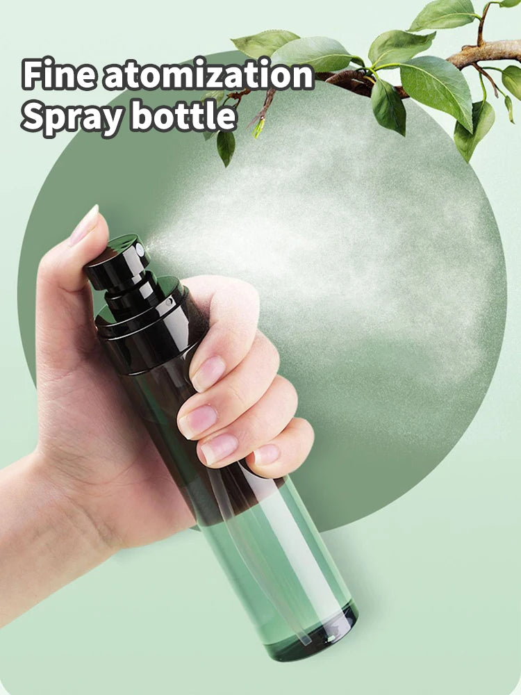 A hand is holding a dark glass spray bottle with a fine mist, set against a light green background.