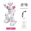 A pink interactive dancing robot toy with remote control and accessories.
