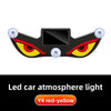 A black demon eye window decal with yellow and red accents and clear lenses for car atmosphere lighting.