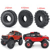 Three sizes of soft rubber tires J K and L 62mm for RC crawler cars with a red off-road vehicle.