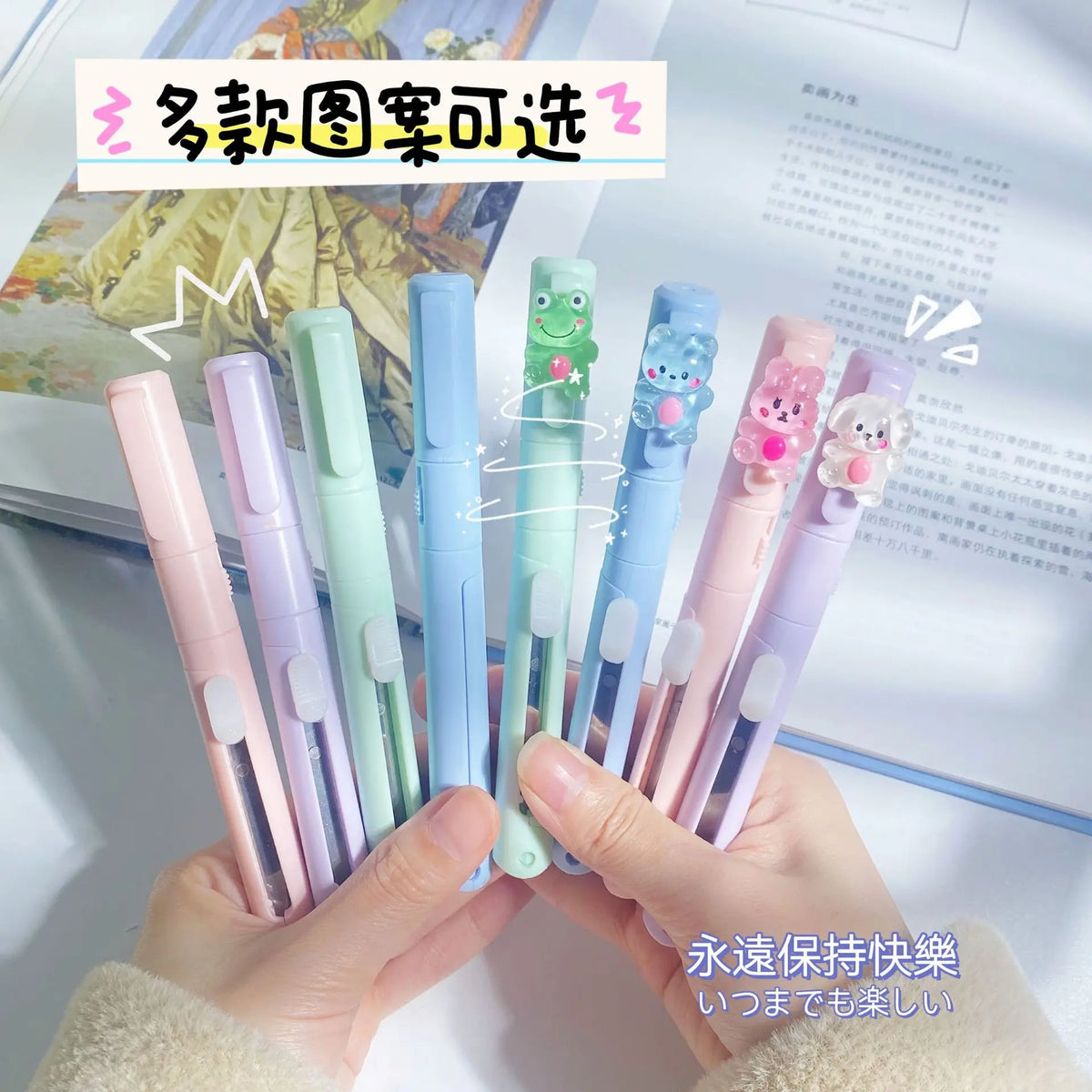A hand holds several colorful folding pen-shaped safety scissors for craft and office.