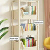 A white 2-5 tier rolling storage cart is shown on a floor, holding handmade ornaments, reading books, and plush toys.