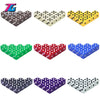 A set of ten multi-color plastic game dice in various patterns including black white yellow green red and blue