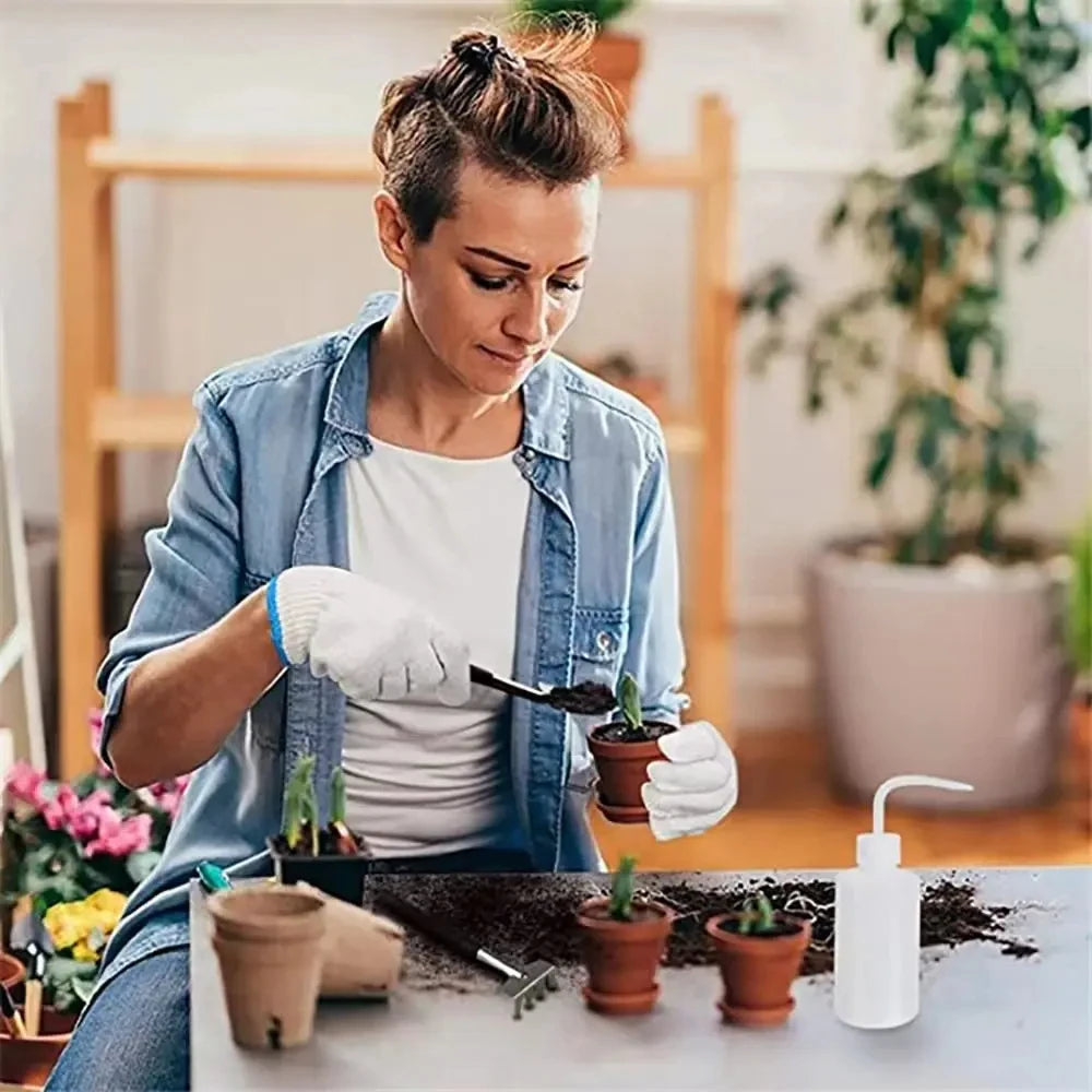 A woman is using a gardening tool kit to care for small potted succulents and bonsai plants.