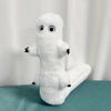 A white plush toy shaped like a ghost with large eyes and outstretched arms sitting on a teal surface.