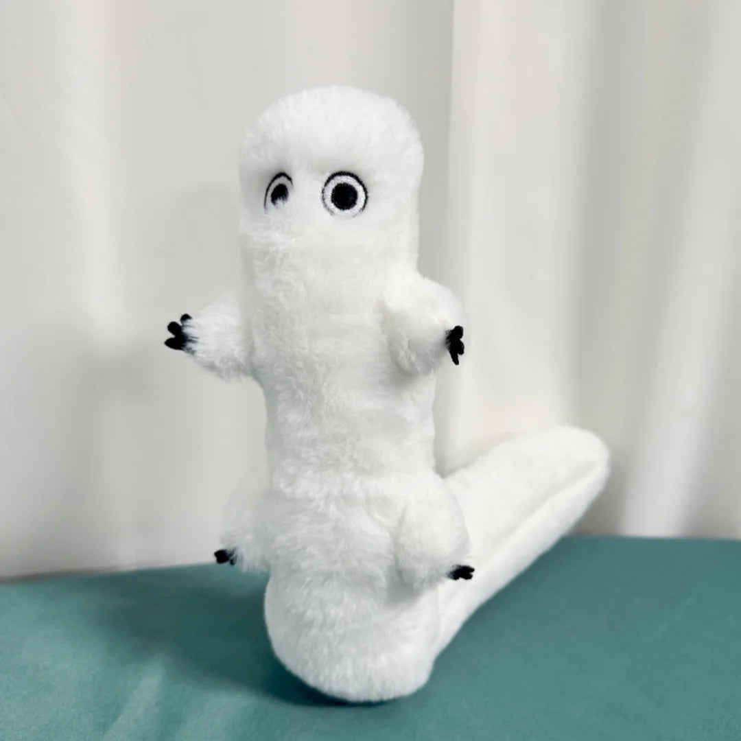 A white plush toy shaped like a ghost with large eyes and outstretched arms sitting on a teal surface.