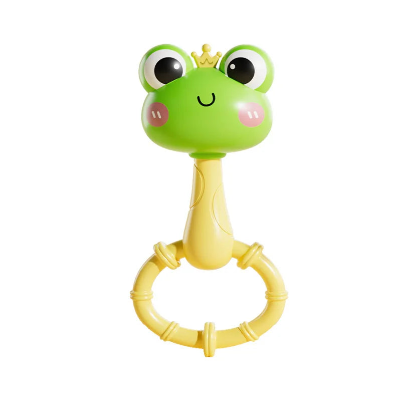 A bright green cartoon frog rattle toy with a gold crown and a yellow ring for grasping.