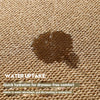 A close-up of a brown fabric surface showing water being absorbed, illustrating the product's water uptake feature.