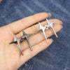 Silver Y2K star waist tightener clips for jeans shown on a hand against a denim background