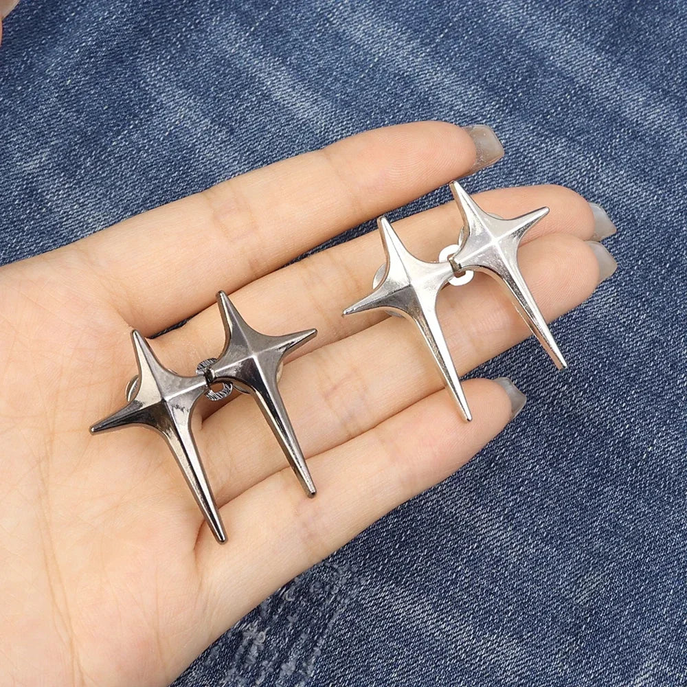 Silver Y2K star waist tightener clips for jeans shown on a hand against a denim background