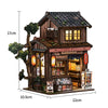 A wooden miniature Japanese sakura tea house kit with an attic roof and display shelves.