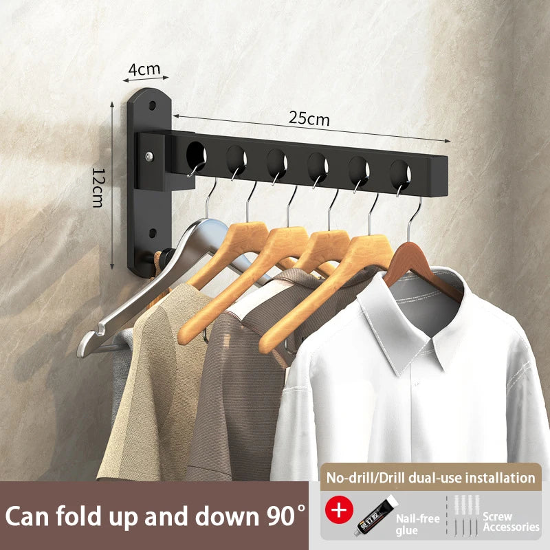 Black foldable wall-mounted clothes drying rack with hooks and a hanger displayed against a wall.