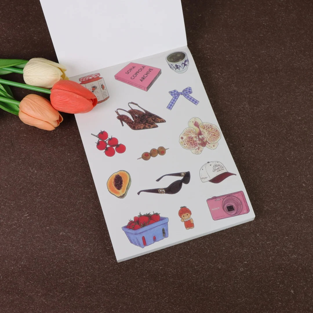 A page from a fruit and letter sticker book featuring various fruit illustrations, leaves, and decorative elements.