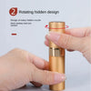 A hand is holding a gold-colored refillable perfume atomizer with a rotating hidden nozzle design.