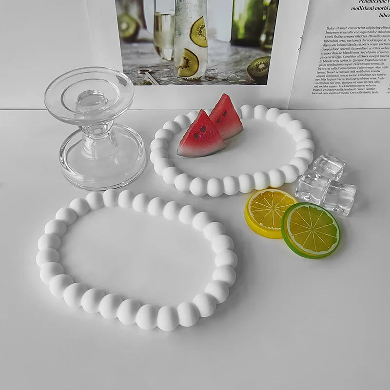 White silicone bubble tray molds for resin, gypsum, and clay crafts displayed with citrus fruit slices.