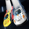 A close-up view of a yellow and blue die-cast racing car on a white track set.