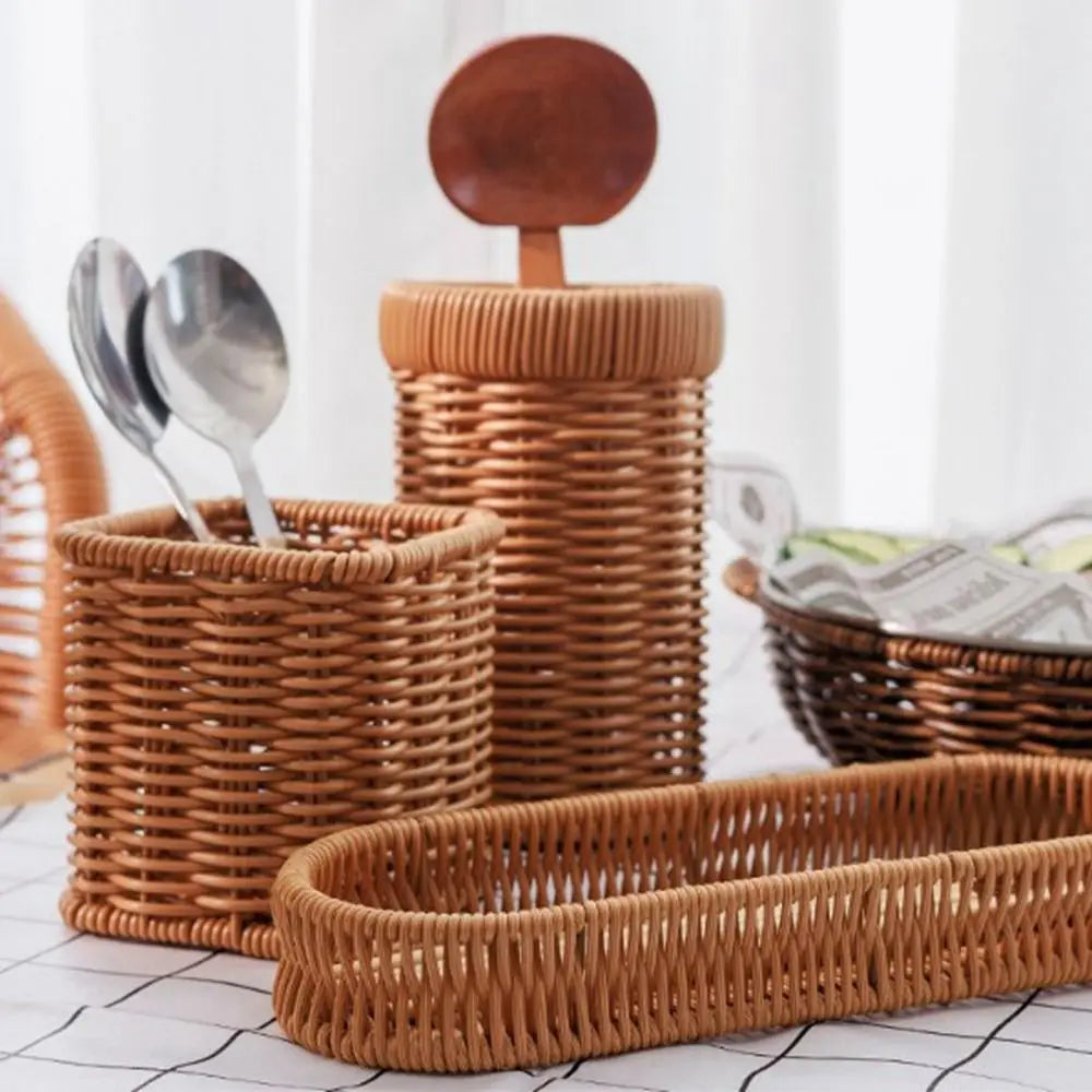 A collection of handwoven wicker serving baskets in various sizes and shapes, stacked on a white surface.