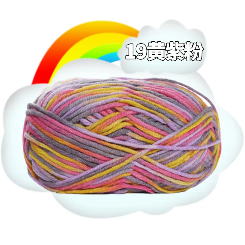 A ball of multi-colored milk cotton blend yarn with a rainbow background.