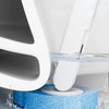 A white wall-mounted holder is shown cleaning a blue, textured surface with water.