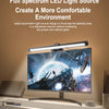 A silver clip-on LED light bar illuminates a desktop area next to a computer monitor.