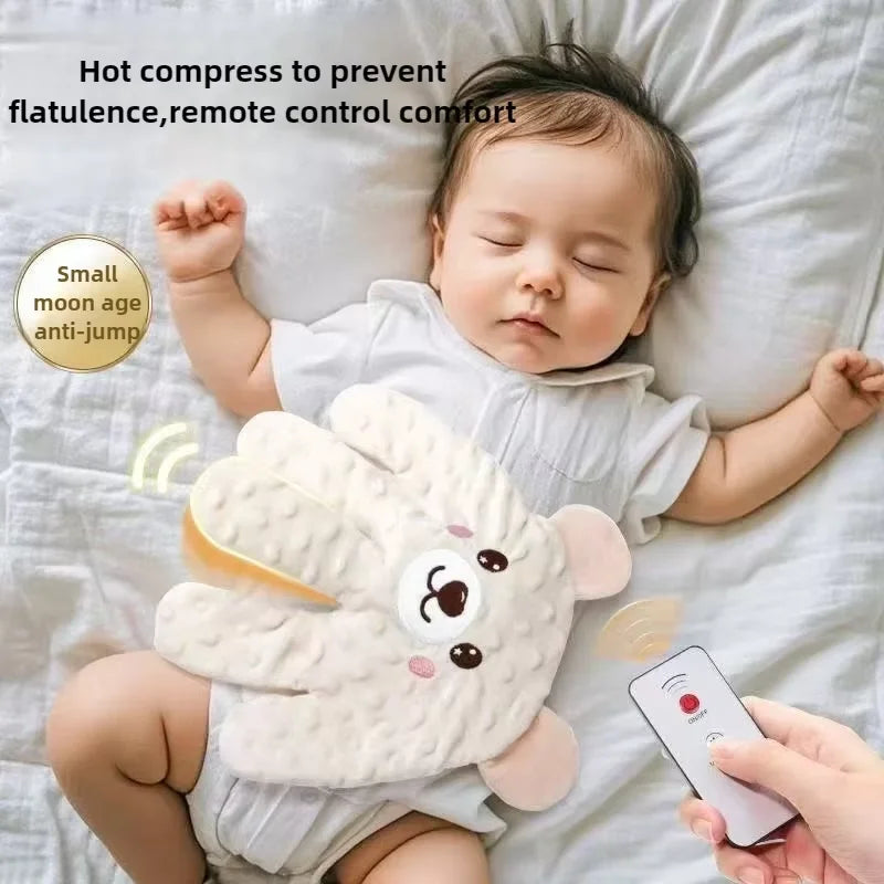 A baby is resting on a white pillow with a soft, palm-shaped anti-jump comfort item and a remote control device.