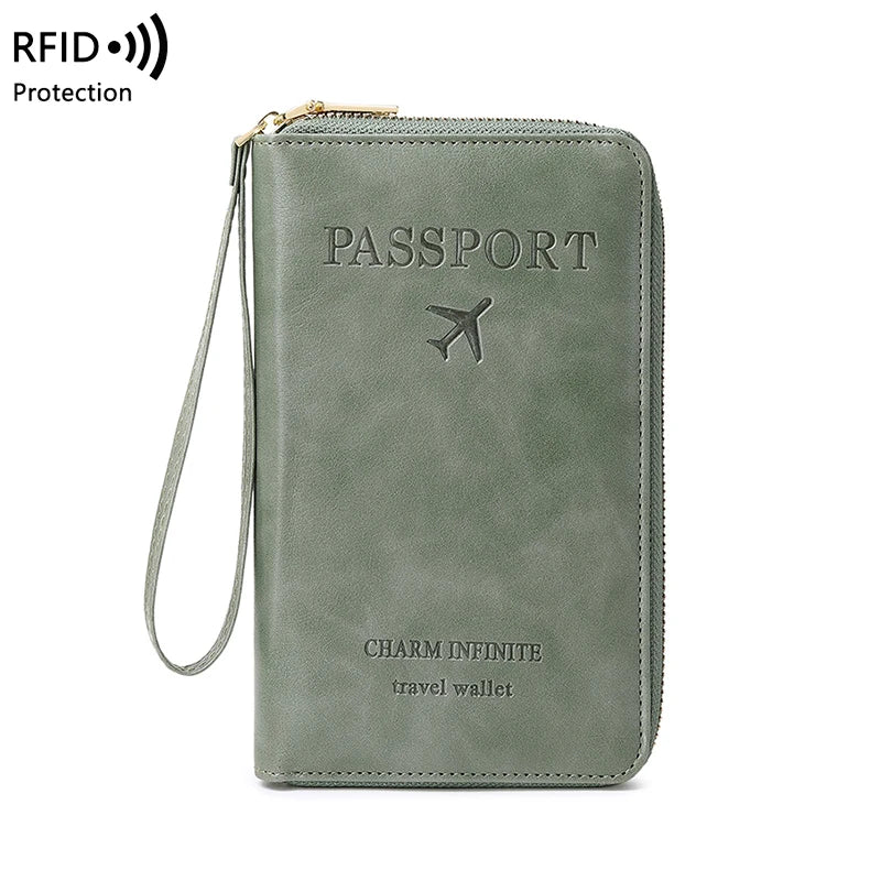 A green leather passport wallet with a zipper and wrist strap, featuring the text PASSSPORT and CHARM INFINITE travel wallet.